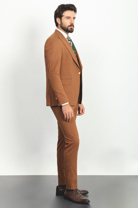 Man wearing a camel 3-piece suit with a white shirt and patterned tie.