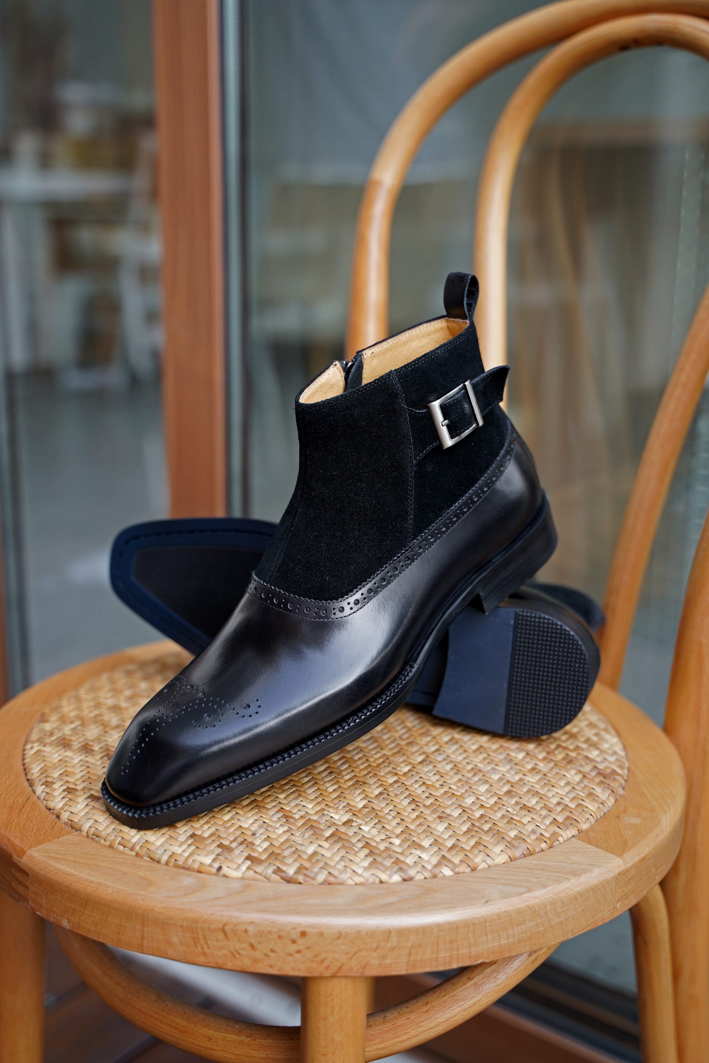A pair of Black Suede and Leather Buckle Boots, featuring a polished finish and buckle strap, perfect for formal occasions and business attire.