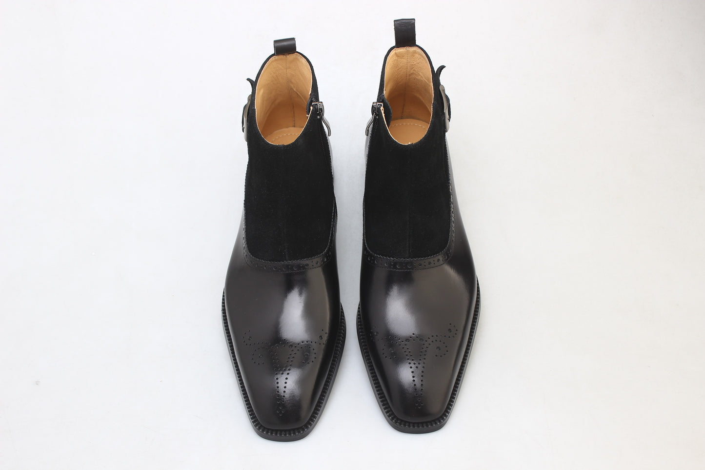 A pair of Black Suede and Leather Buckle Boots, featuring a polished finish and buckle strap, perfect for formal occasions and business attire.
