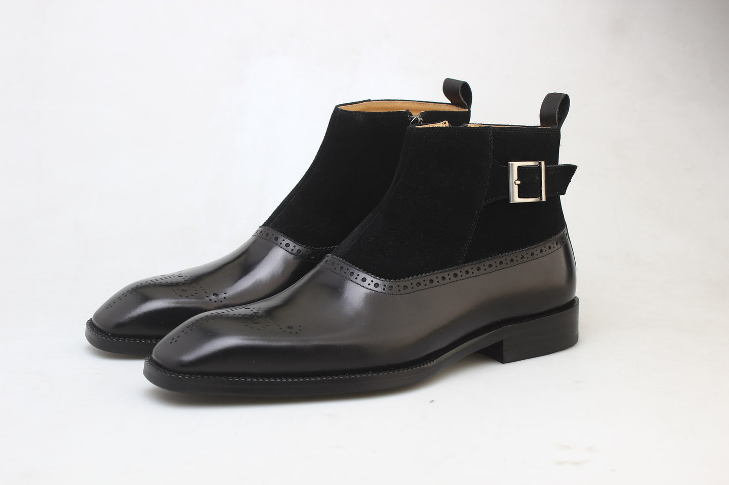 A pair of Black Suede and Leather Buckle Boots, featuring a polished finish and buckle strap, perfect for formal occasions and business attire.