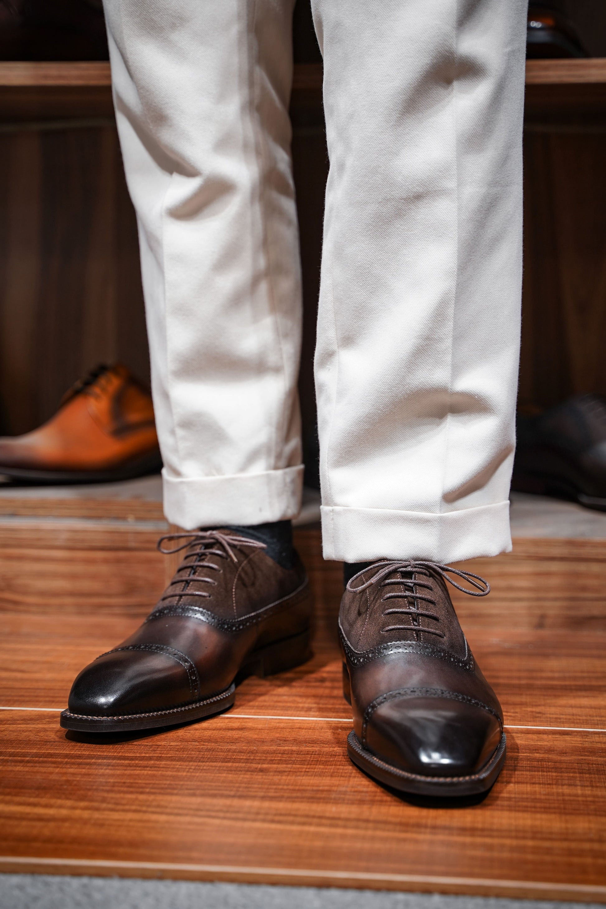 Top view of men's chestnut leather and suede oxford shoes, featuring a two-tone design and cap-toe detailing, perfect for formal occasions and luxury fashion.