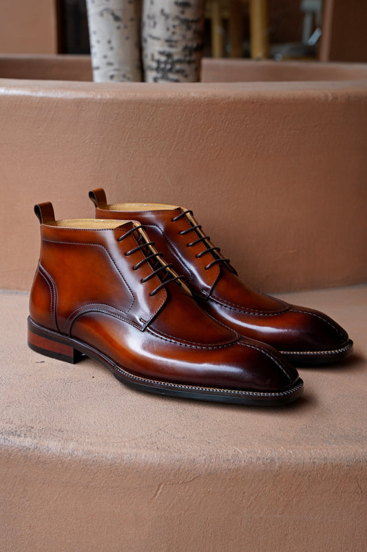 A pair of handcrafted Brown Windsor Lace-Up Boots, made from polished leather, showcasing a sleek and elegant design ideal for formal and casual wear.
