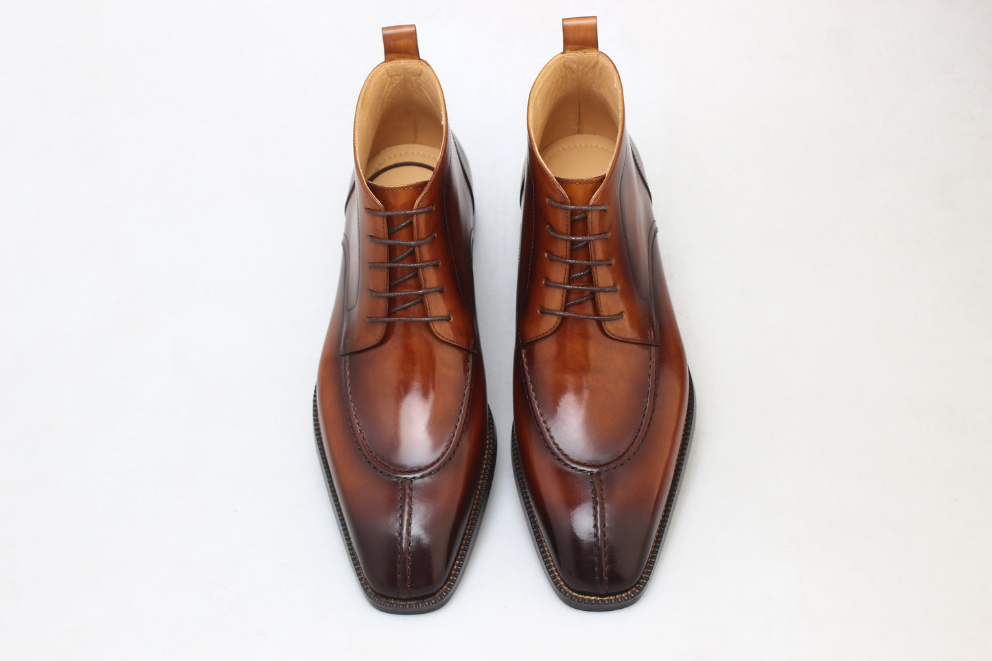 A pair of handcrafted Brown Windsor Lace-Up Boots, made from polished leather, showcasing a sleek and elegant design ideal for formal and casual wear.