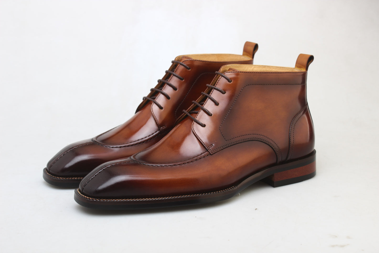A pair of handcrafted Brown Windsor Lace-Up Boots, made from polished leather, showcasing a sleek and elegant design ideal for formal and casual wear.