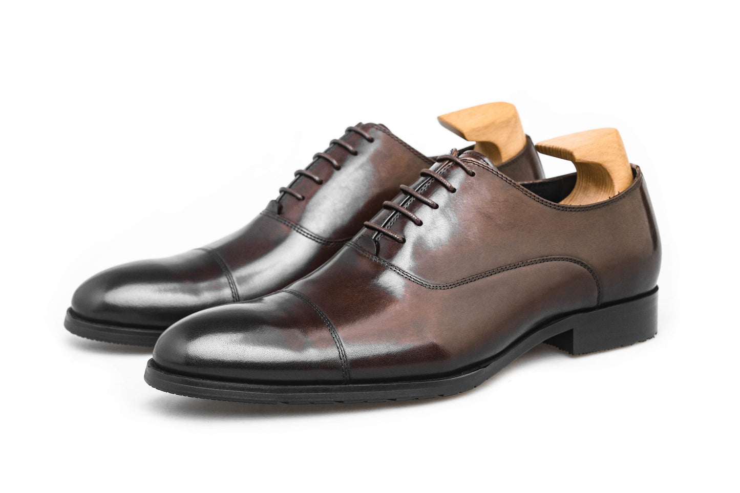 Close-up of men's espresso brown leather oxford shoes with a cap-toe design.