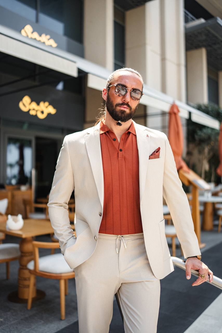 Beige pinstripe suit styled casually with polo shirt – spring/summer outfit