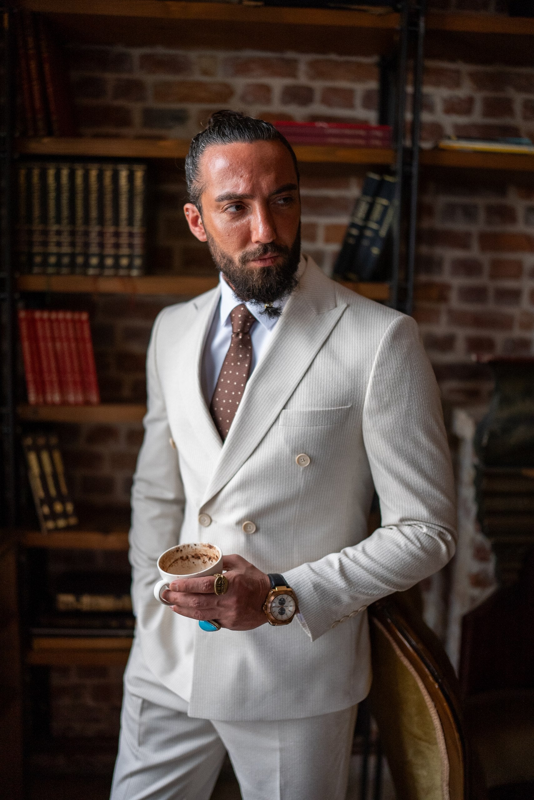 Slim fit beige suit with brown tie, perfect for summer weddings