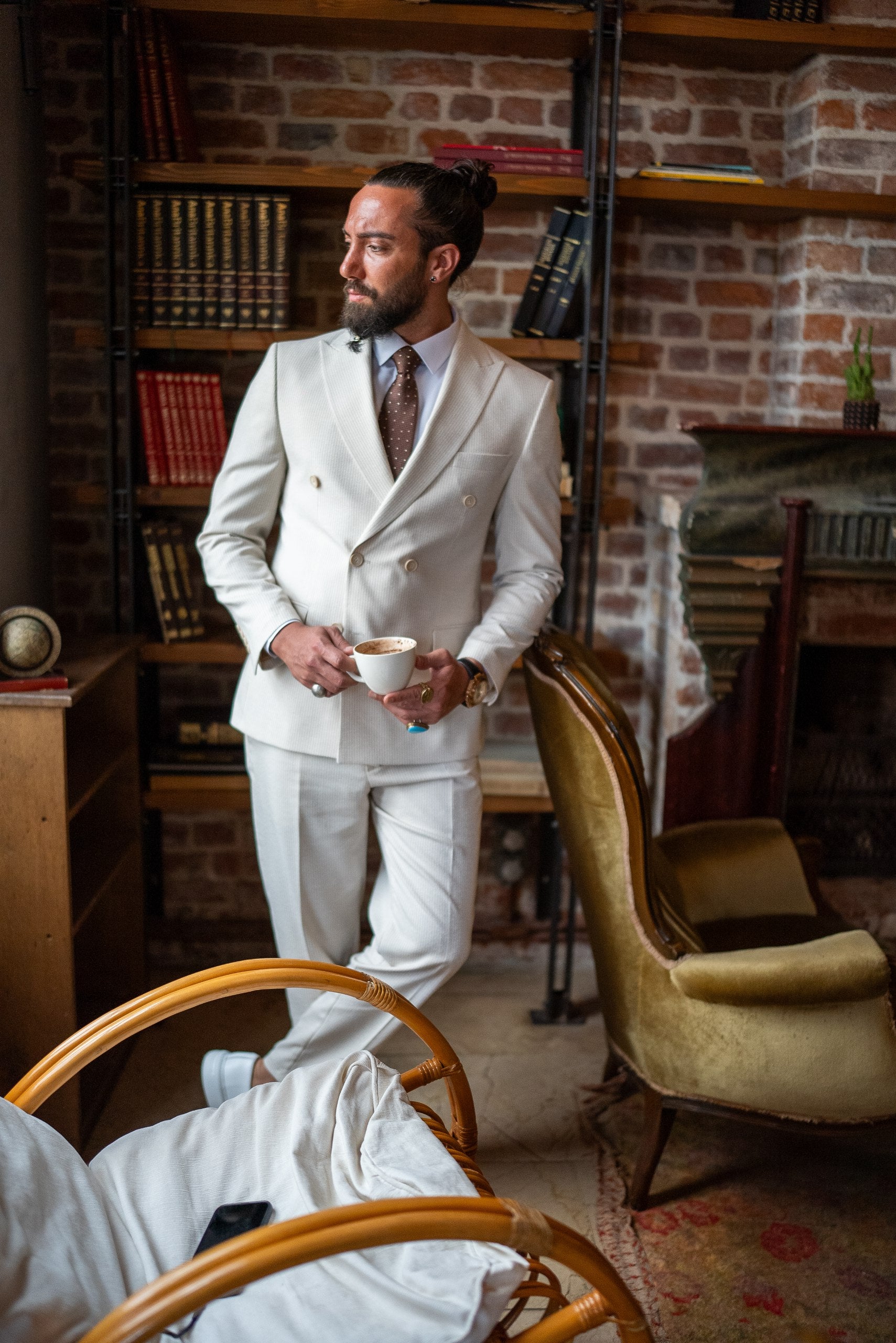 Elegant beige double-breasted suit for men with peak lapels in lifestyle shot