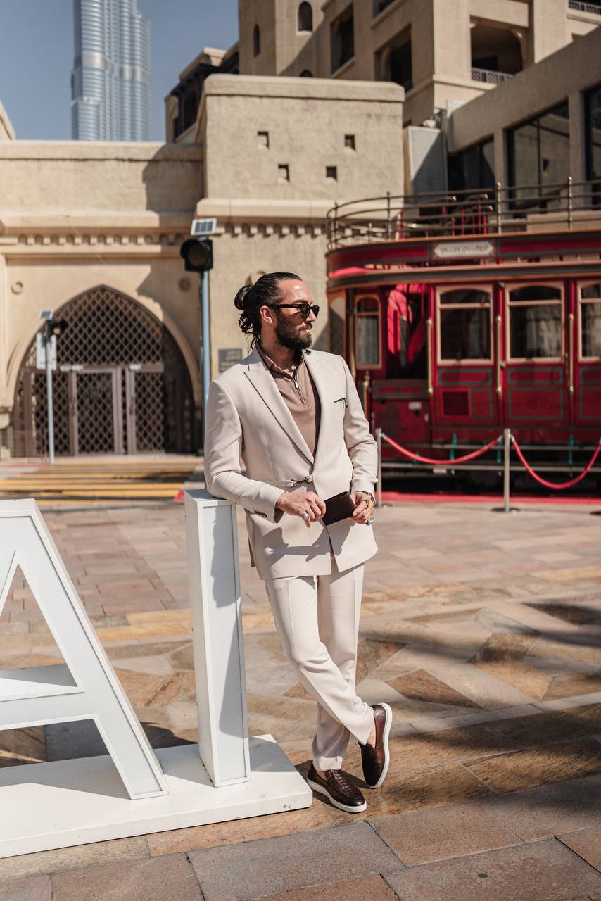 Beige tailored suit styled for urban elegance in front of skyscrapers