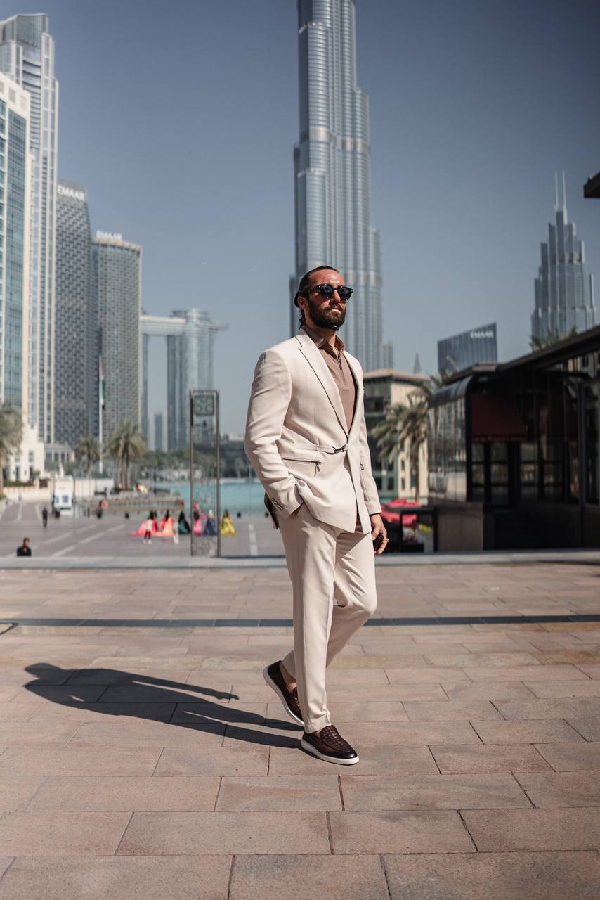 Lifestyle image of beige tailored suit paired with casual shirt and loafers
