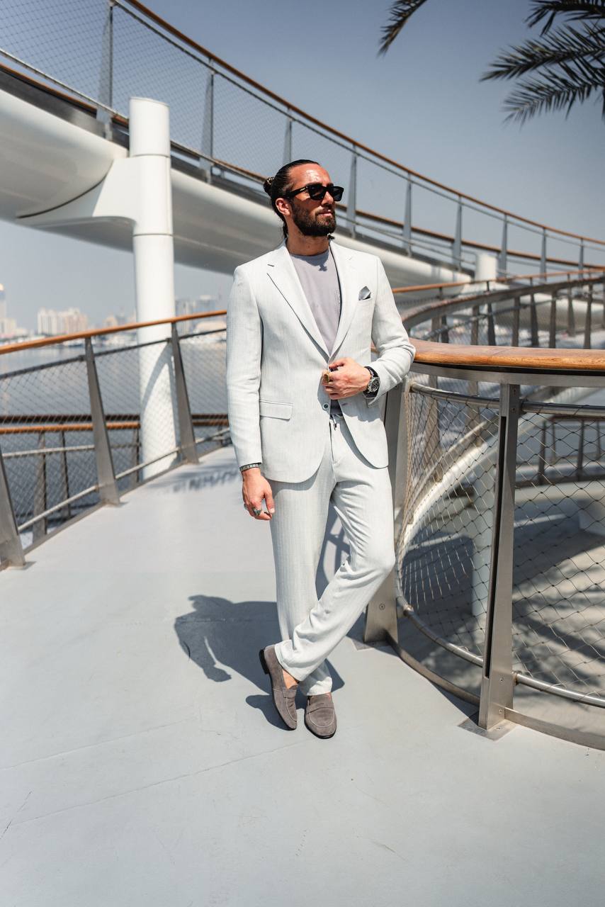Men’s gray slim fit tailored suit with t-shirt styling, outdoor view