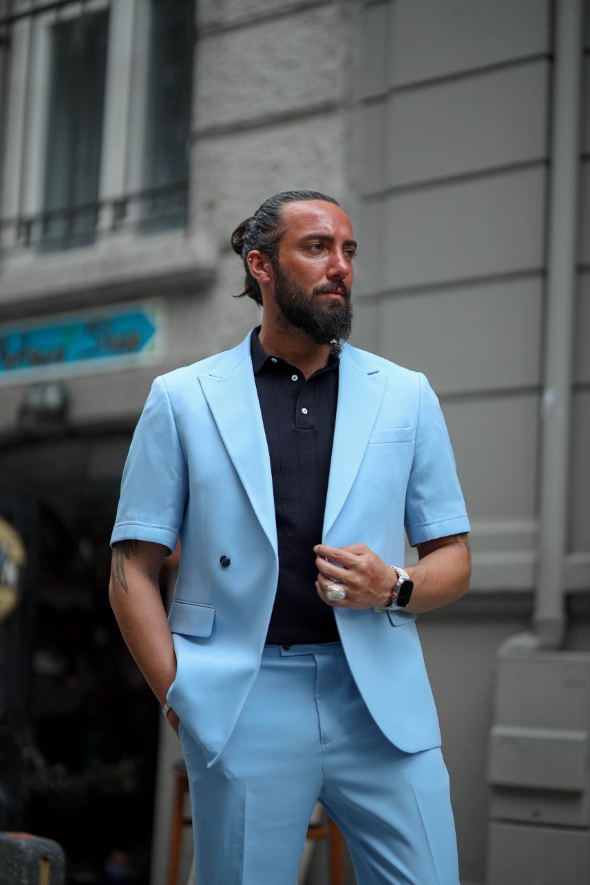 Close-up of men’s tailored light blue summer suit blazer with navy polo, modern slim fit style