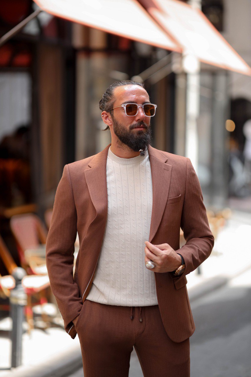 Close-up of men’s light brown tailored summer suit with breathable fabric.