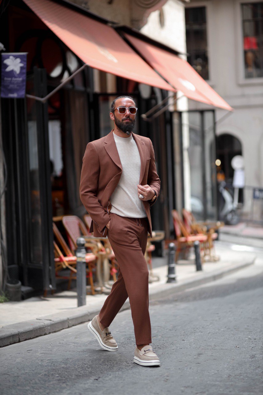 Men’s light brown summer suit paired with loafers for warm-weather elegance.