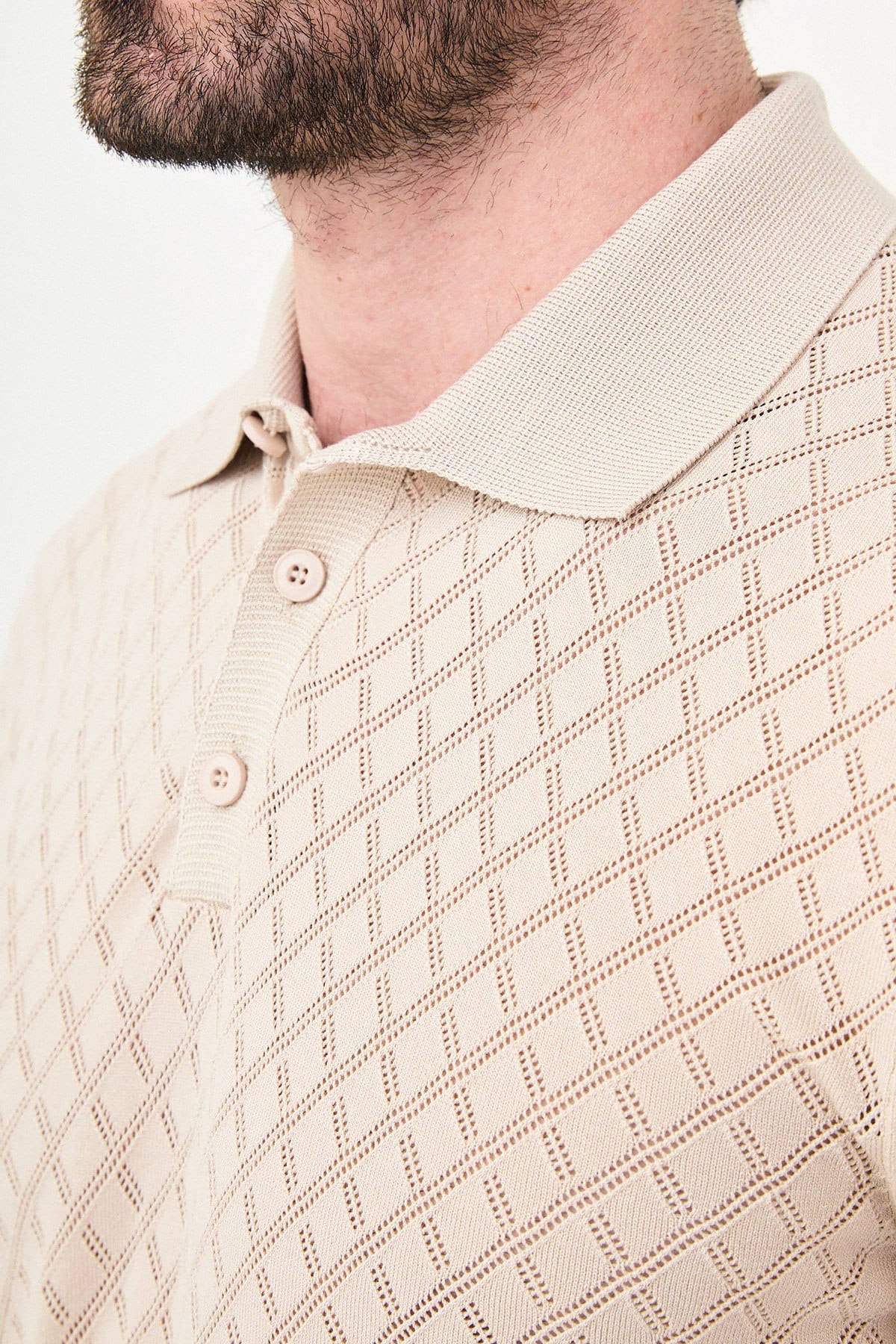 Close-up of a beige patterned shirt with a collar