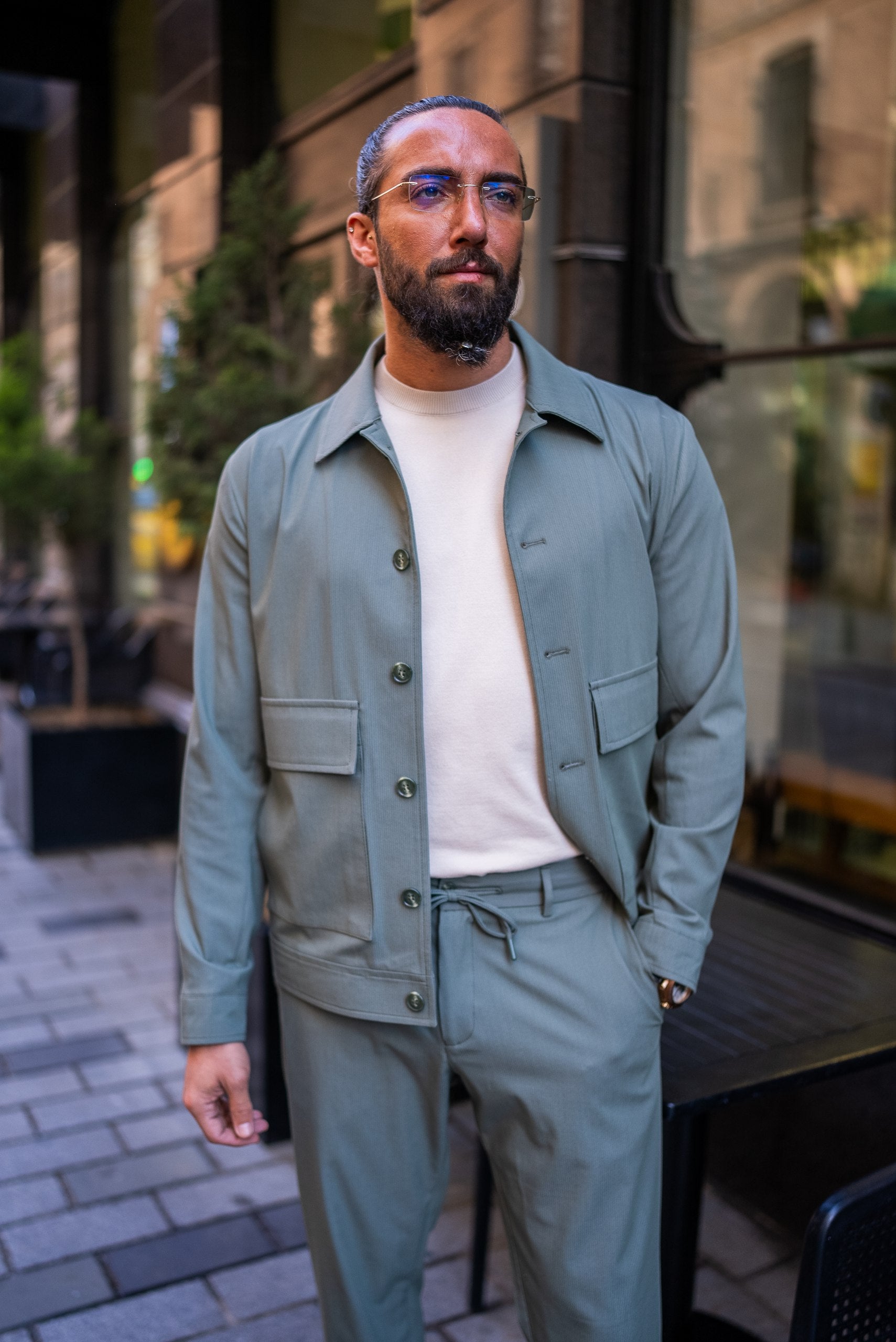 Sage green men’s co-ord set styled for a rooftop summer event