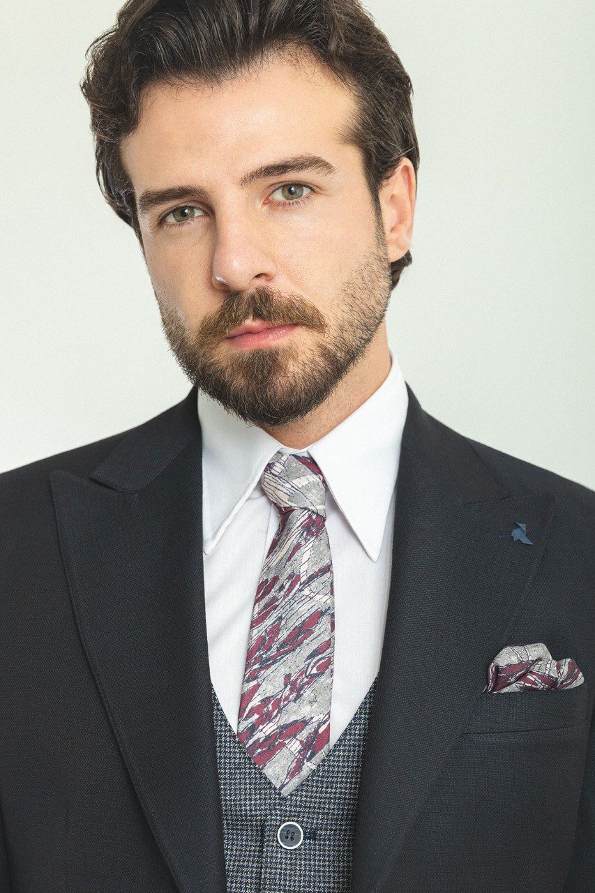 Man wearing a Patterned Dark Gray Suit with a black jacket and gray vest.