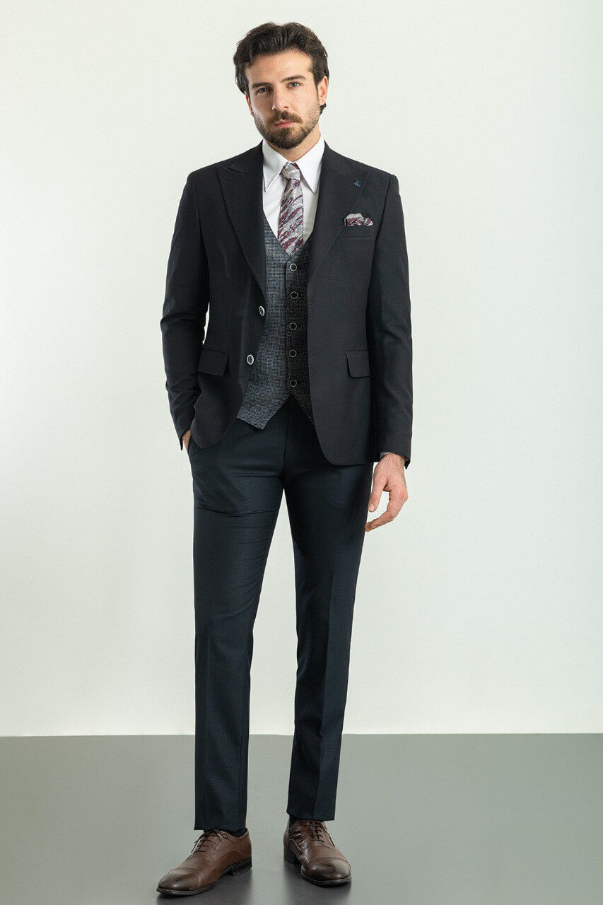 Man wearing a Patterned Dark Gray Suit with a black jacket and gray vest.