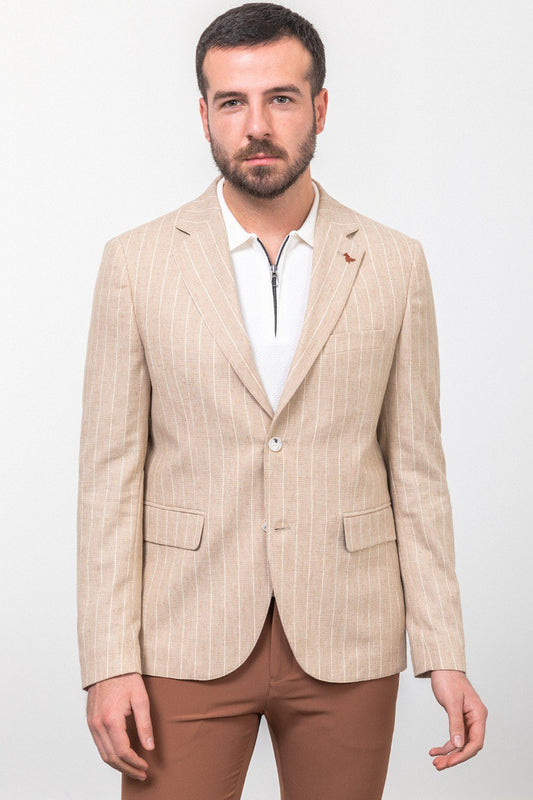 Man wearing a beige pinstripe blazer paired with brown trousers.
