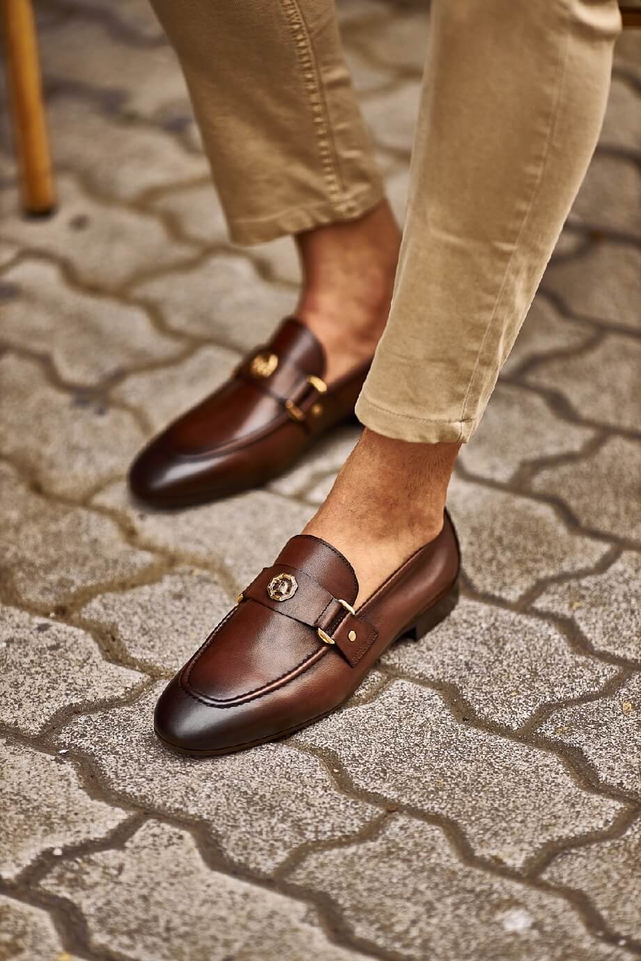 Brown penny loafers with a buckle detail, ideal for groomsmen and fall weddings, showcasing timeless style and comfort.