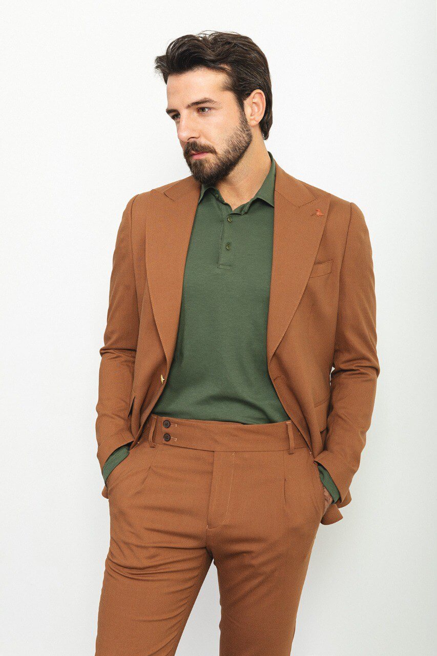 Man wearing a camel 3-piece suit with a white shirt and patterned tie.