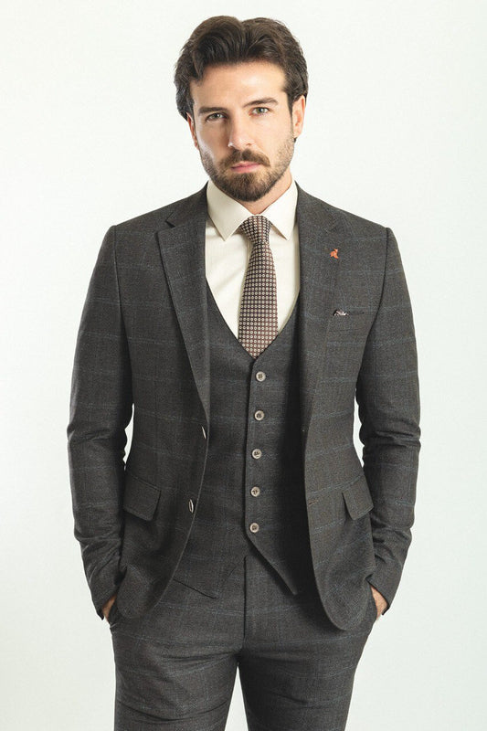 Man in a dark blue patterned 3-piece suit, showcasing elegance and style.