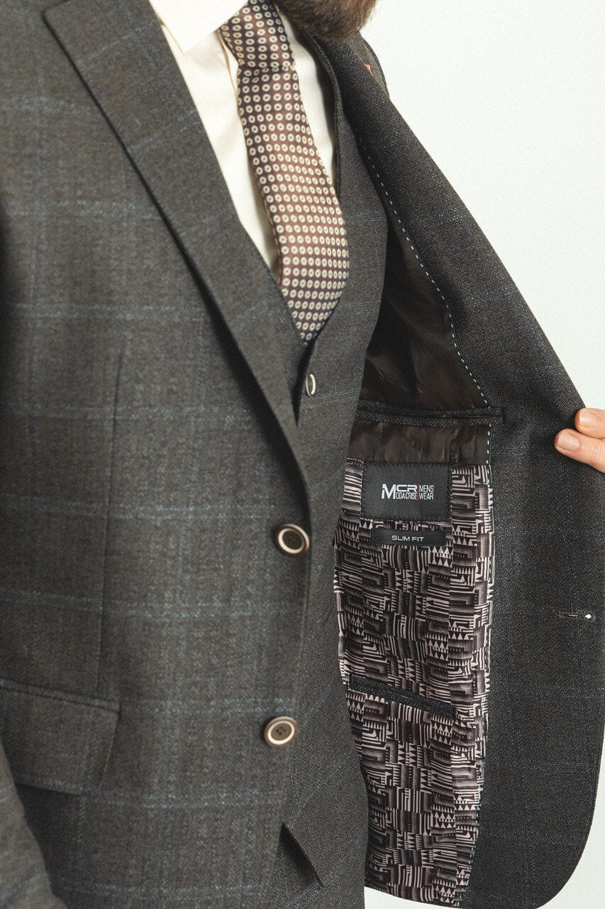 Man in a dark blue patterned 3-piece suit, showcasing elegance and style.
