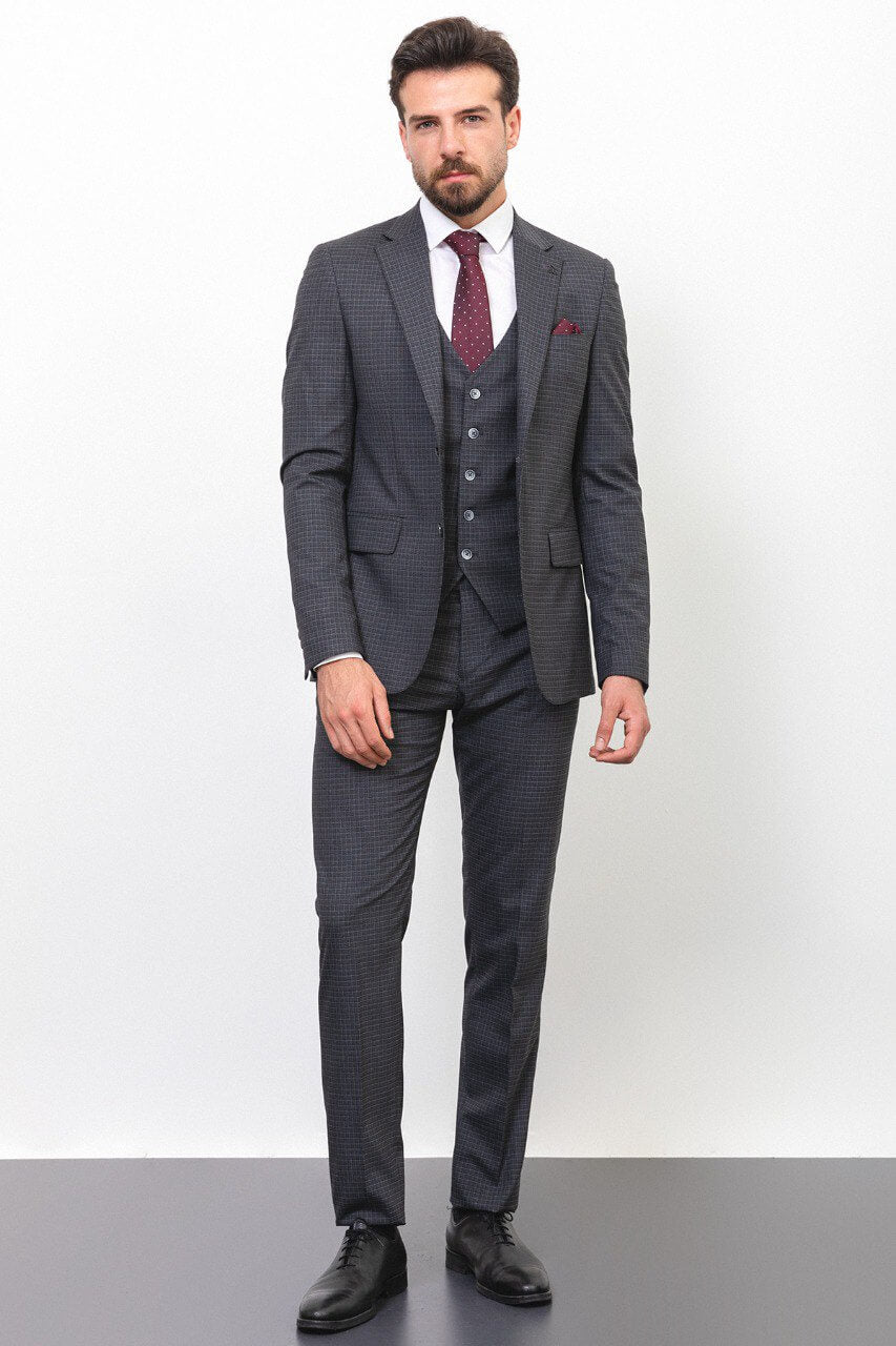 Man wearing a dark gray checkered suit with a burgundy tie and pocket square.