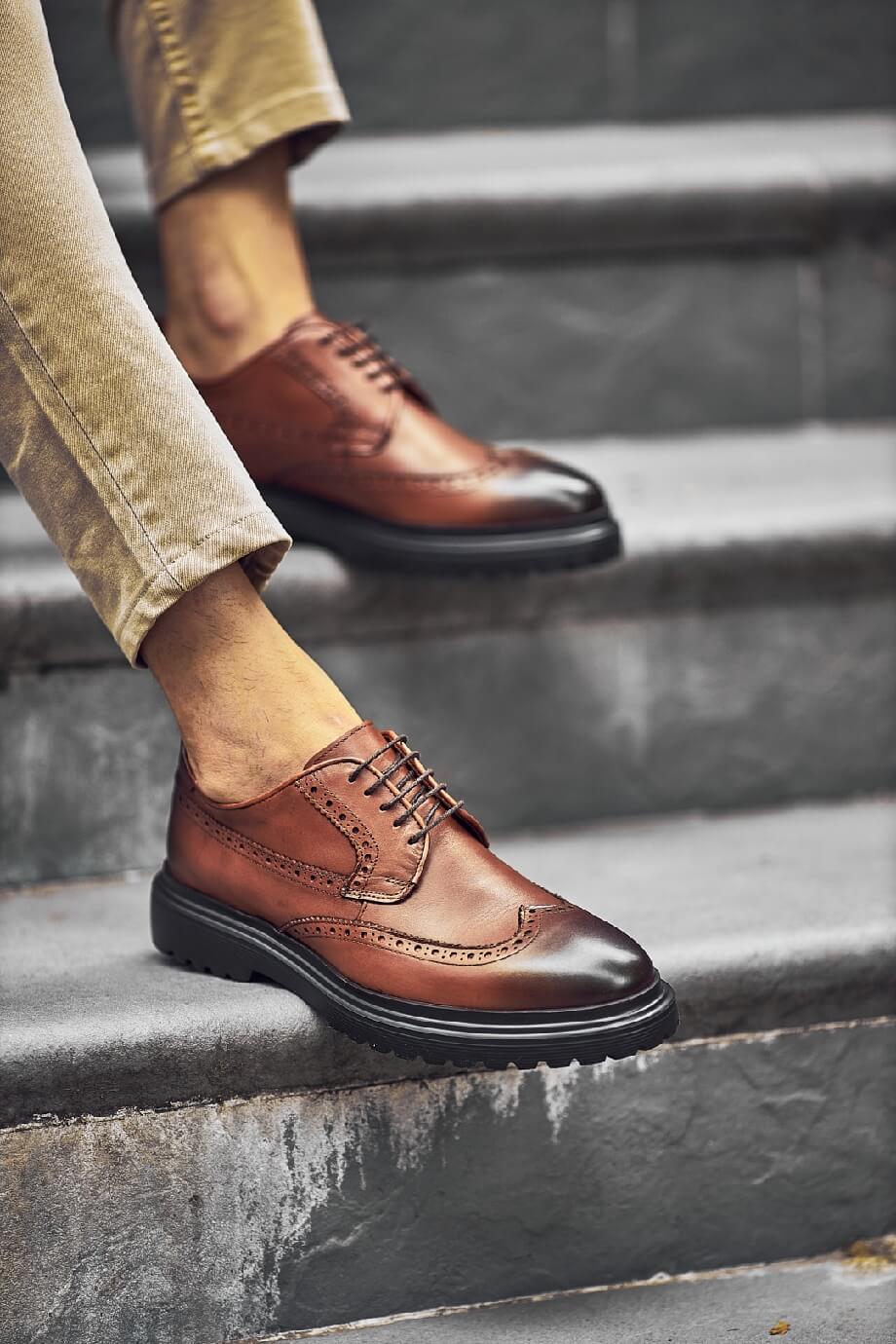 Close-up of Suitharbor Camel Leather Brogues worn with khaki pants, ideal leather dress shoes for weddings and formal events.