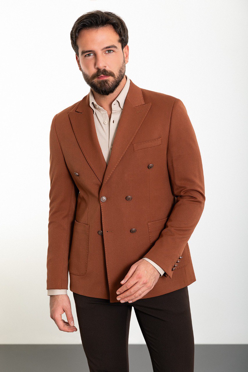 Man in a stylish brown double-breasted blazer paired with a beige shirt.