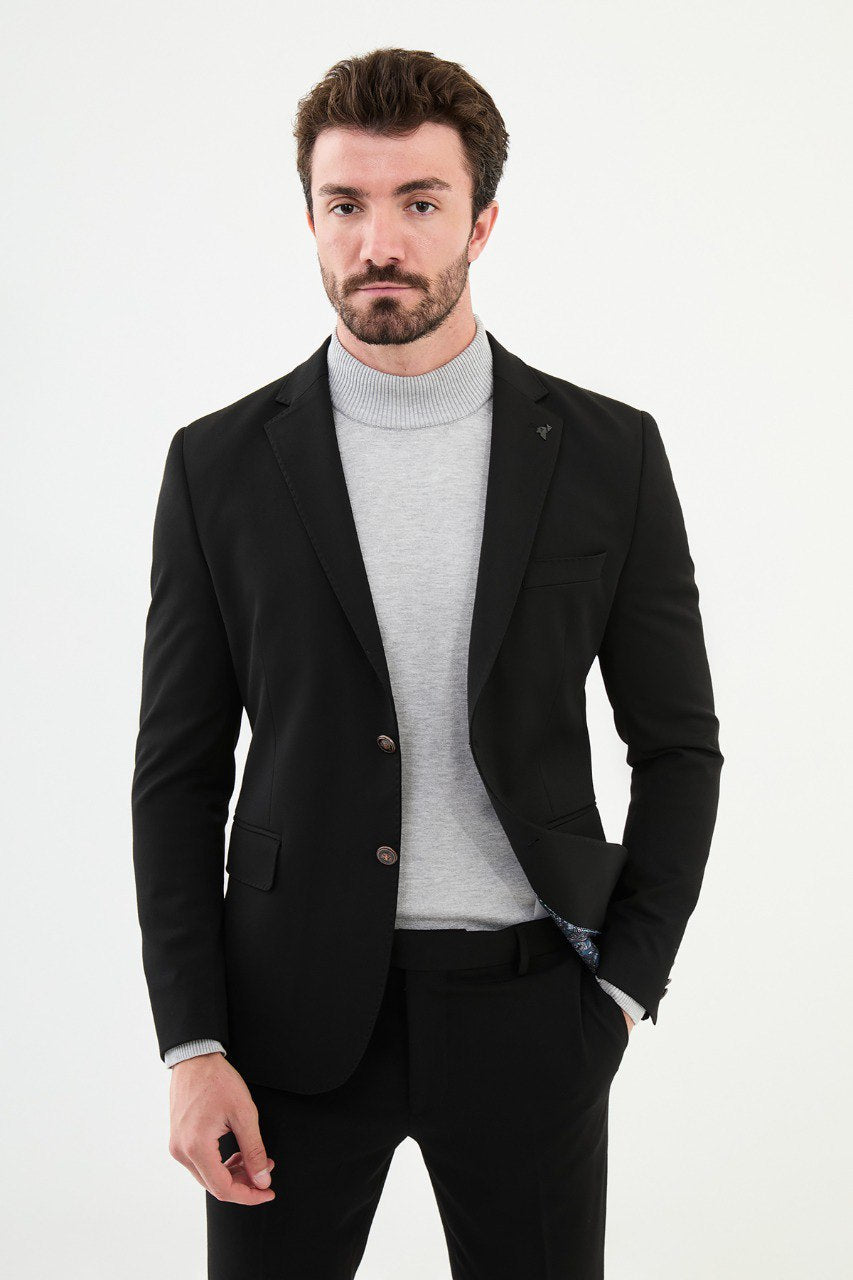 Man wearing a black blazer with a light gray turtleneck, perfect for a sharp, modern, business-casual look.