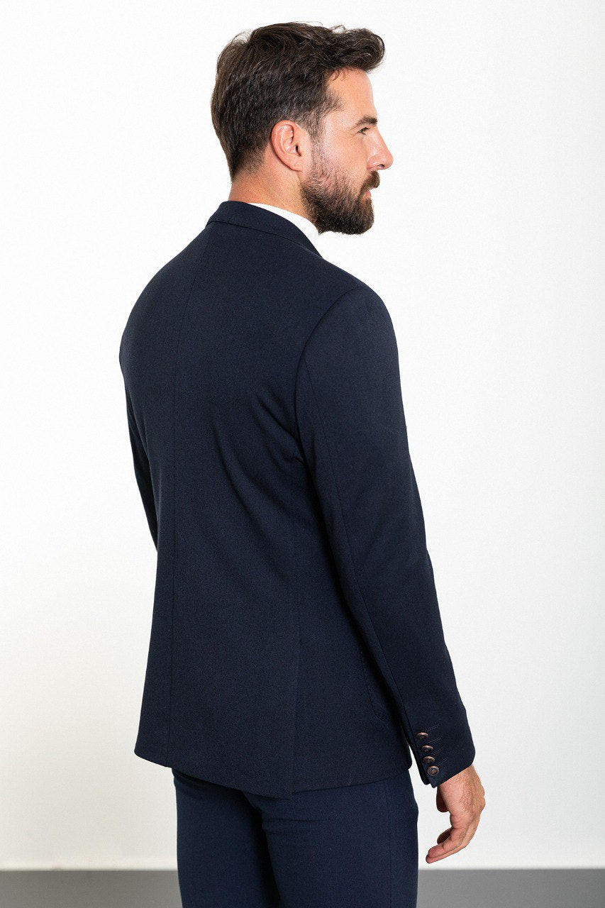Man wearing a navy double-breasted blazer with a white turtleneck, perfect for formal and smart-casual occasions.