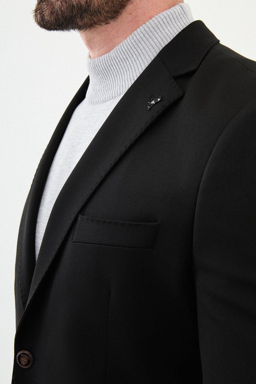 Man wearing a black blazer with a light gray turtleneck, perfect for a sharp, modern, business-casual look.