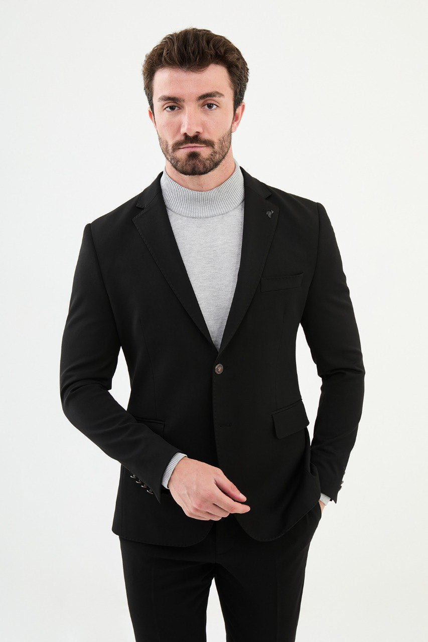 Man wearing a black blazer with a light gray turtleneck, perfect for a sharp, modern, business-casual look.