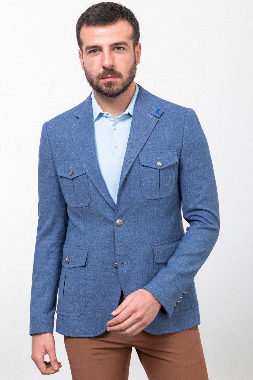 Man wearing a blue blazer with brown trousers, perfect for smart-casual or business-casual attire.