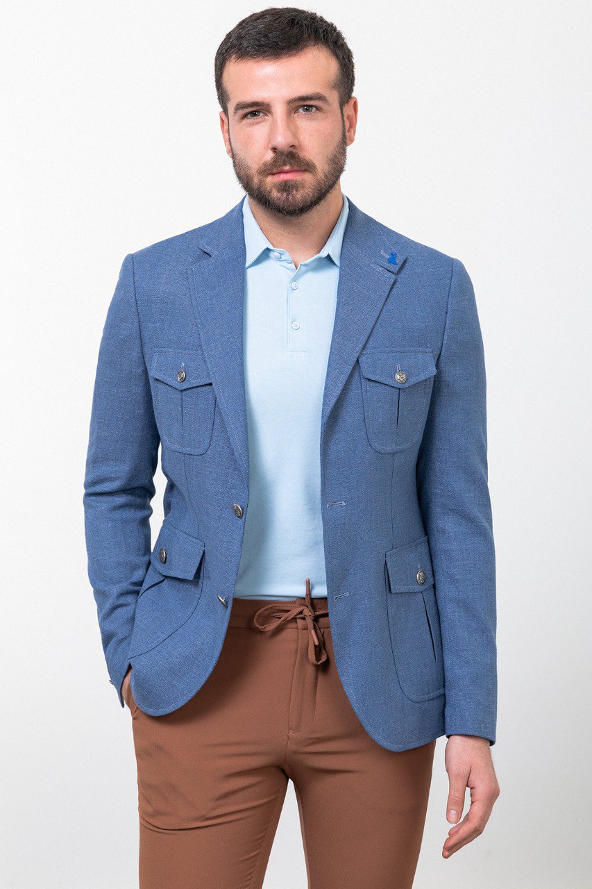 Man wearing a blue blazer with brown trousers. Perfect for smart-casual or business-casual attire.