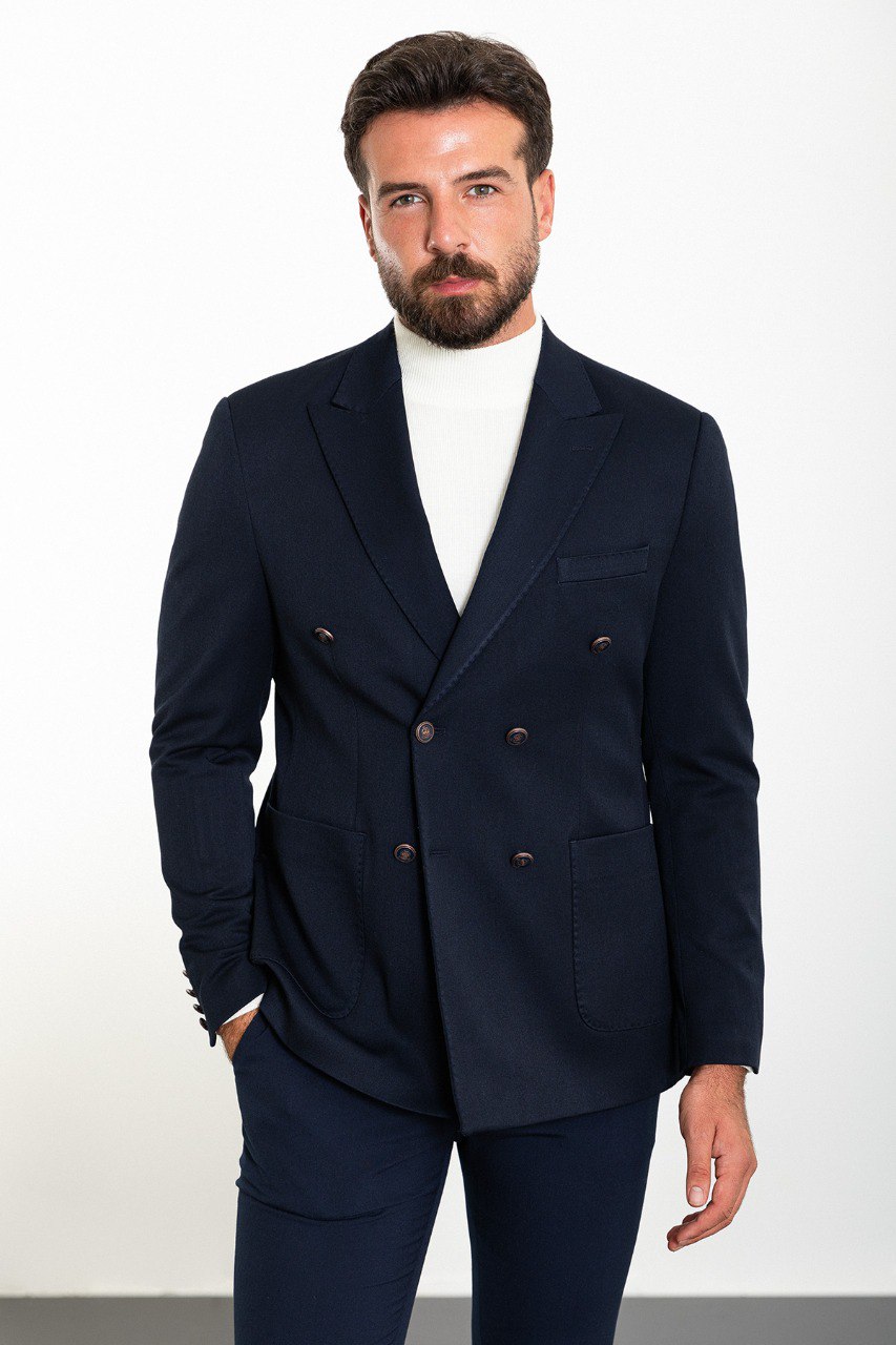 Man wearing a navy double-breasted blazer with a white turtleneck, perfect for formal and smart-casual occasions.