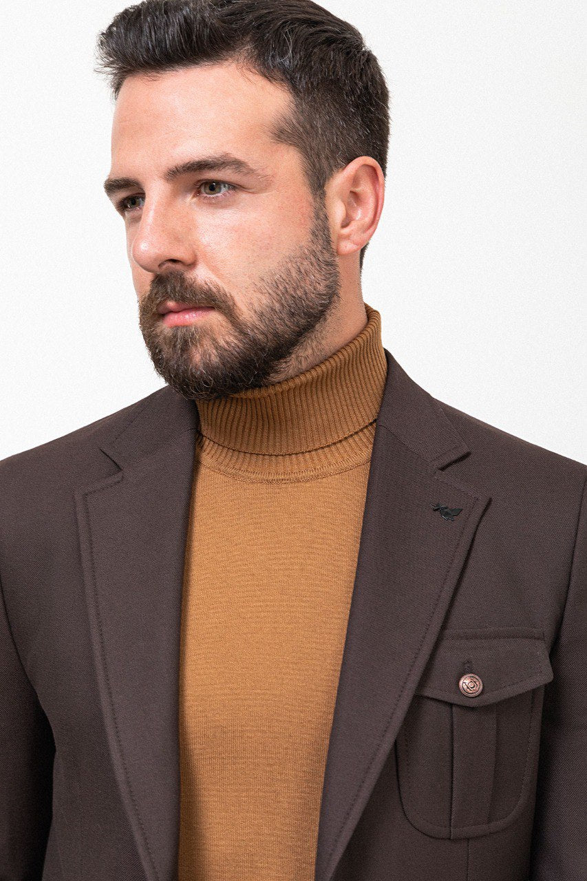 Man wearing a dark brown blazer with a tan turtleneck.