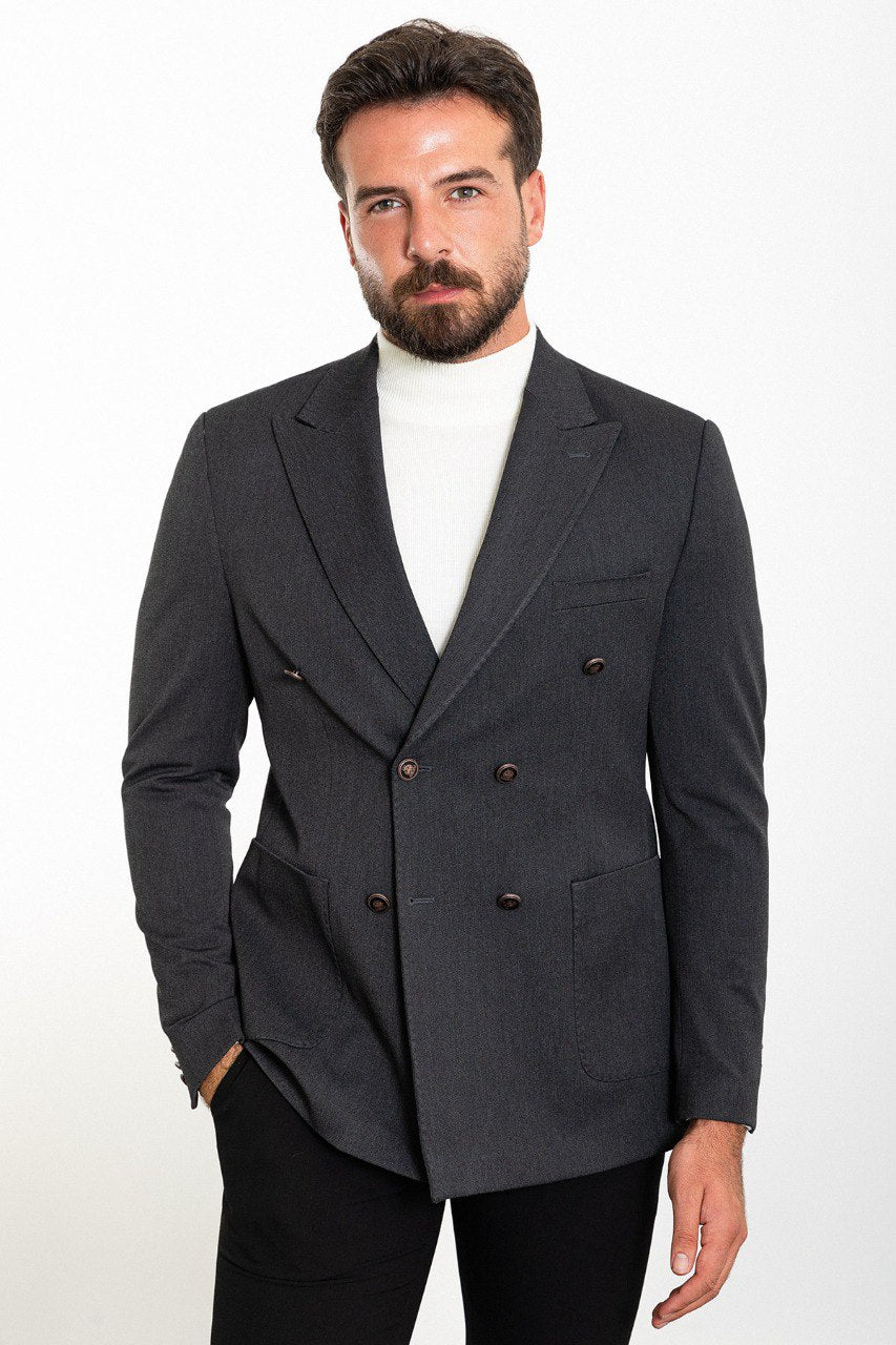 "Man wearing a gray double-breasted blazer paired with a white turtleneck.
