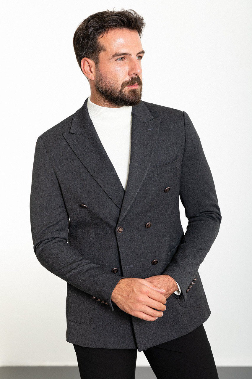 "Man wearing a gray double-breasted blazer paired with a white turtleneck.