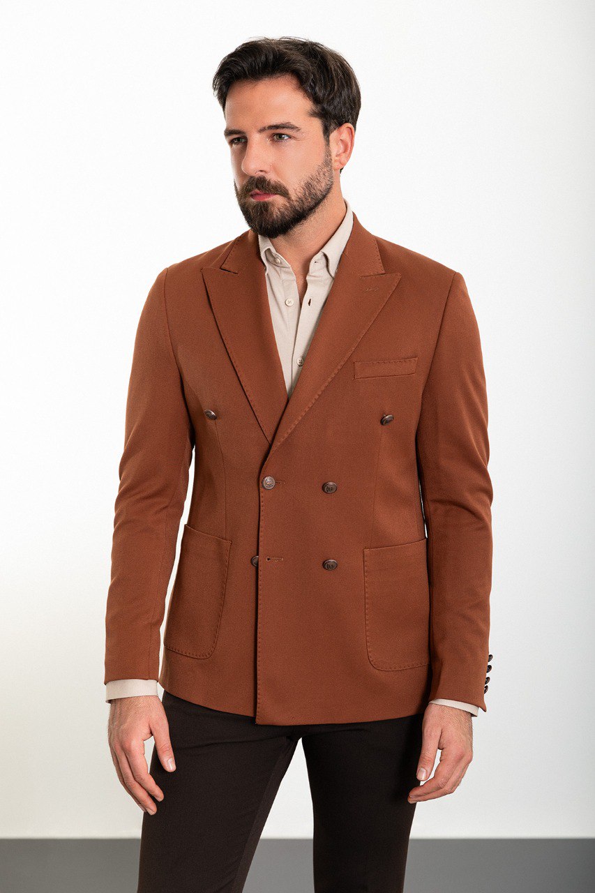 Man in a stylish brown double-breasted blazer paired with a beige shirt.