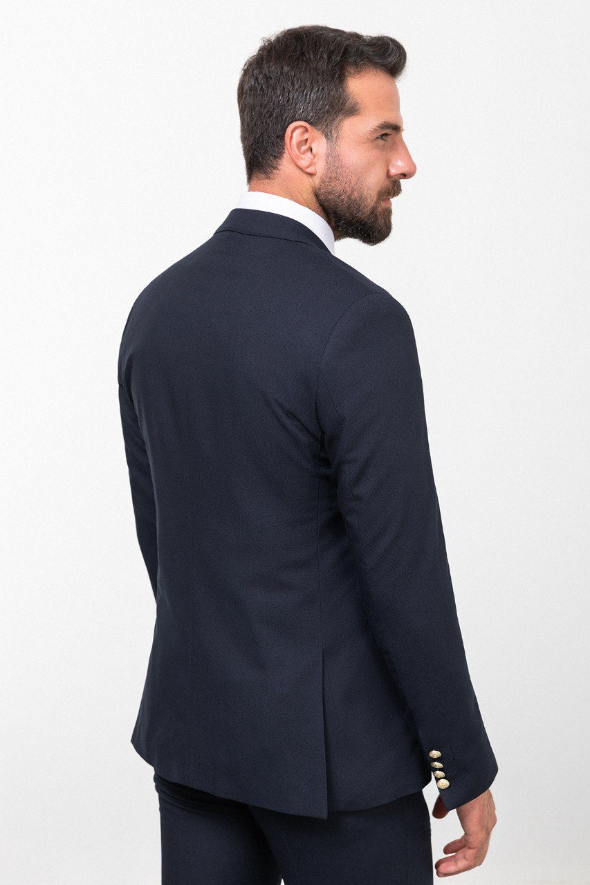 Man wearing a navy blue 3-piece suit with a gold tie.