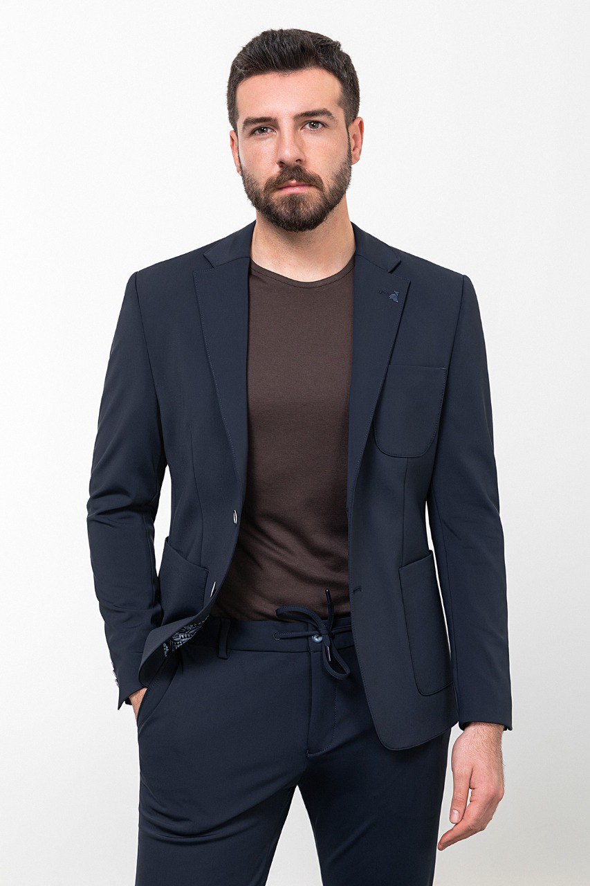 Man wearing a navy blue leisure suit.