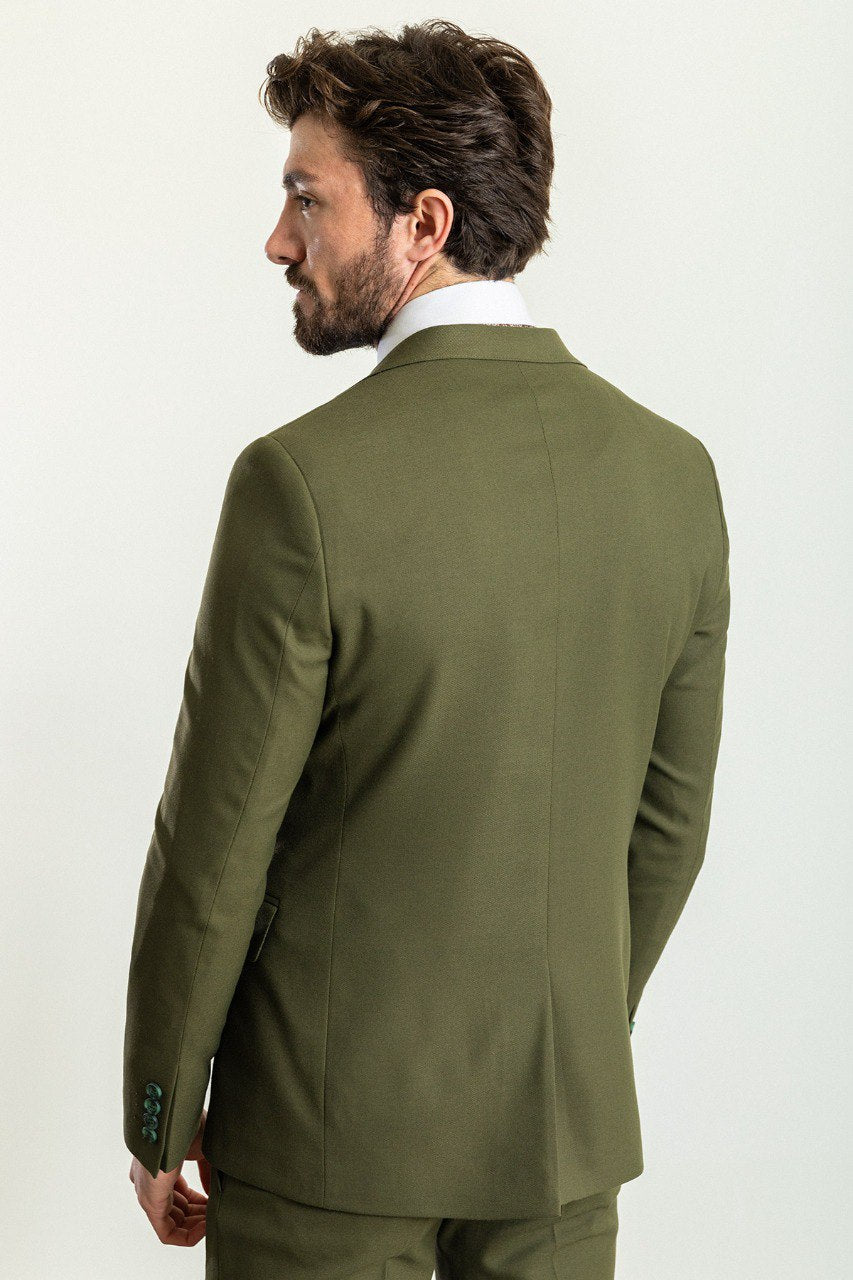 Man wearing an Olive Grove Suit with a sharp pointed collar, flap pockets, and a slim fit, perfect for weddings and business engagements.