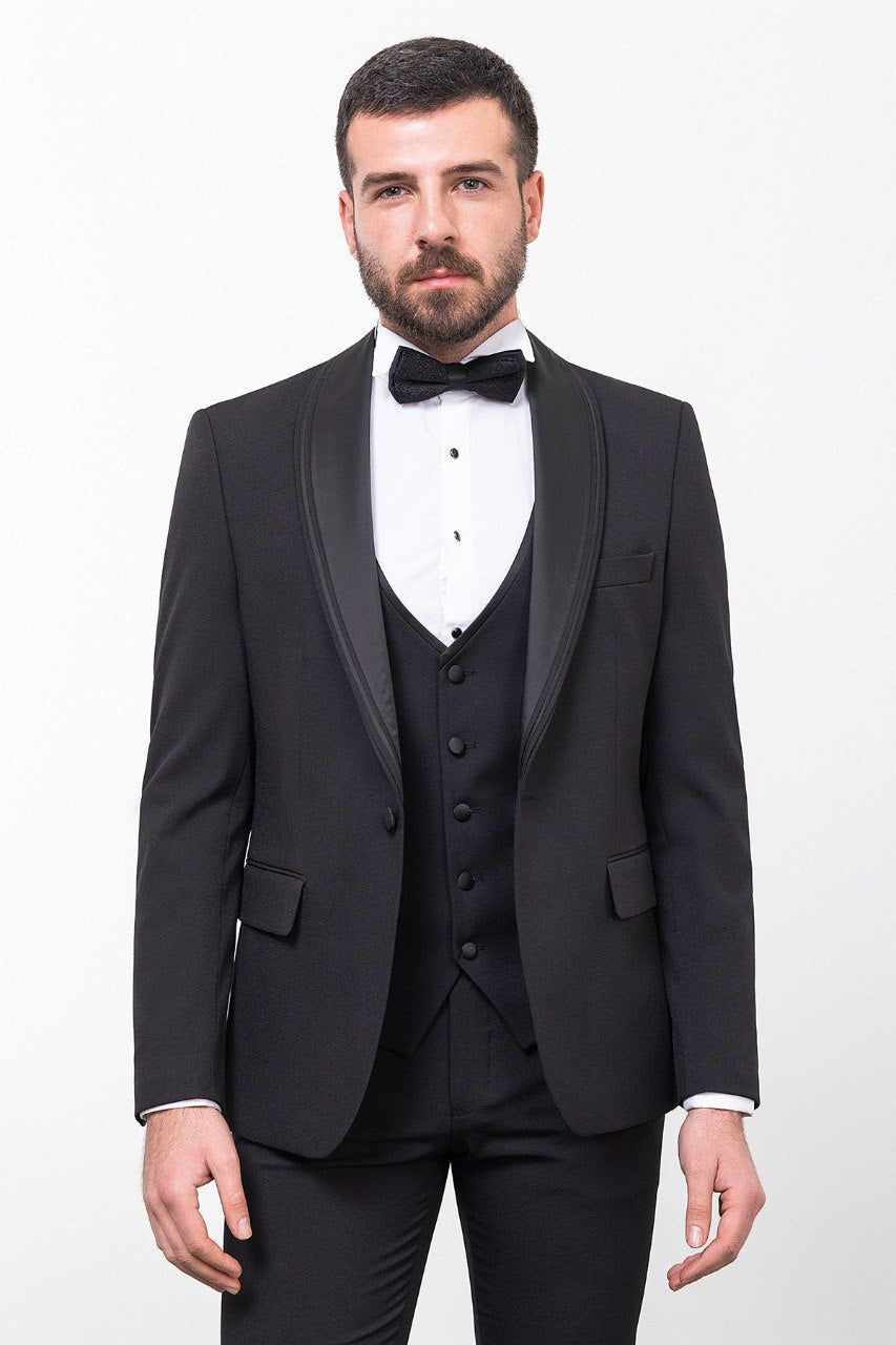 Man wearing a black 3-piece suit with a bow tie.