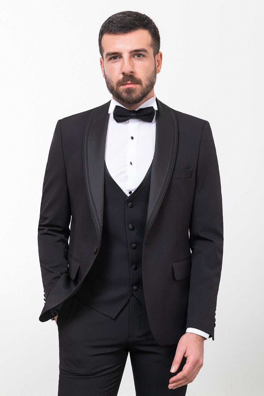Man wearing a black 3-piece suit with a bow tie.