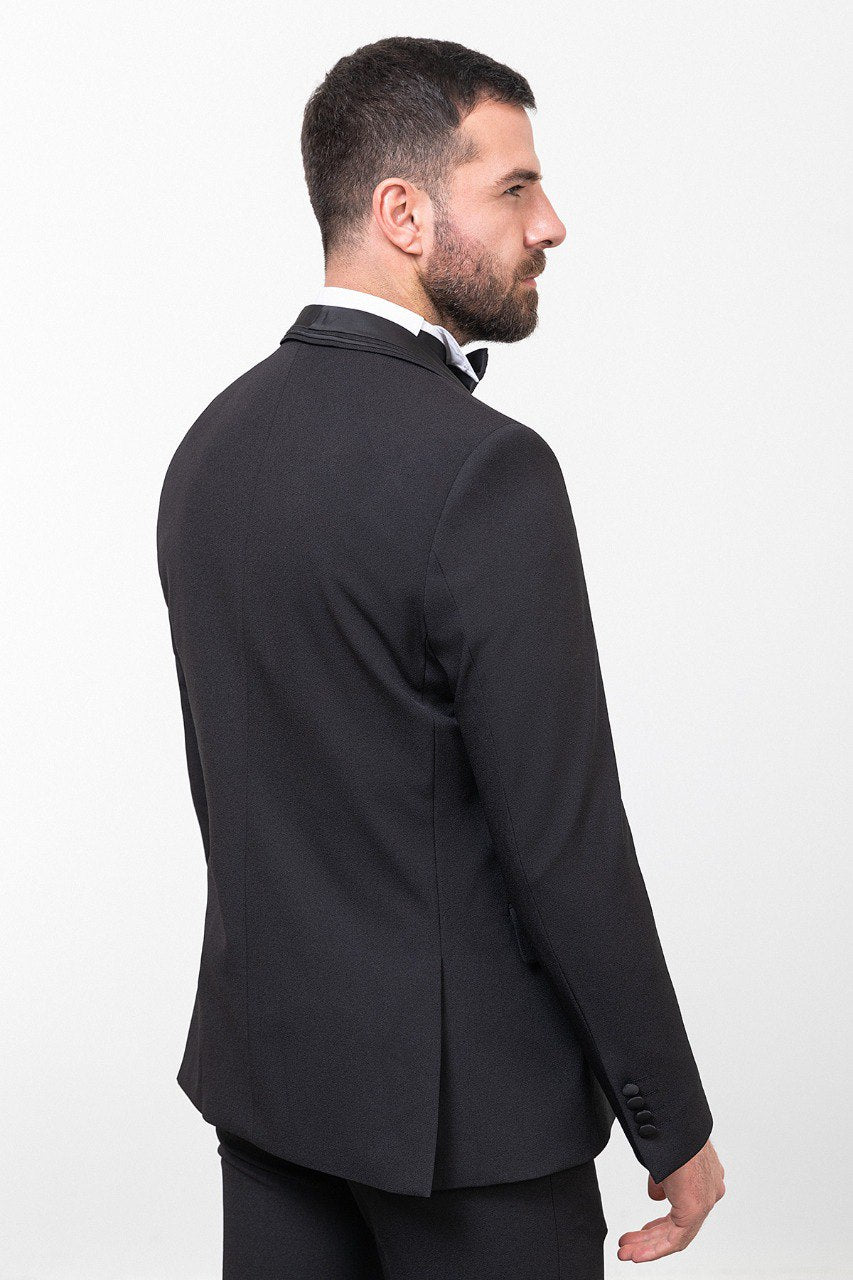 Man wearing a black 3-piece suit with a bow tie.