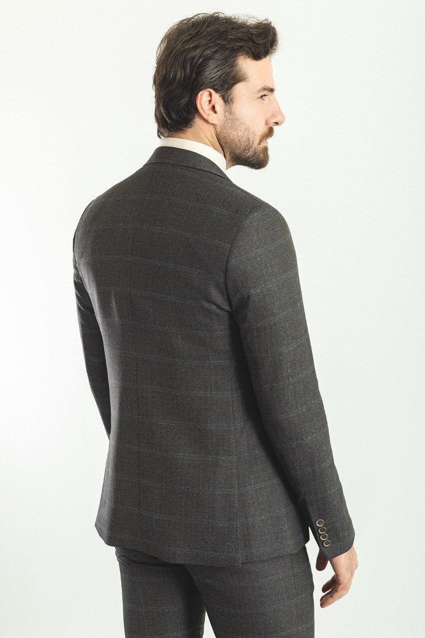 Man in a dark blue patterned 3-piece suit, showcasing elegance and style.