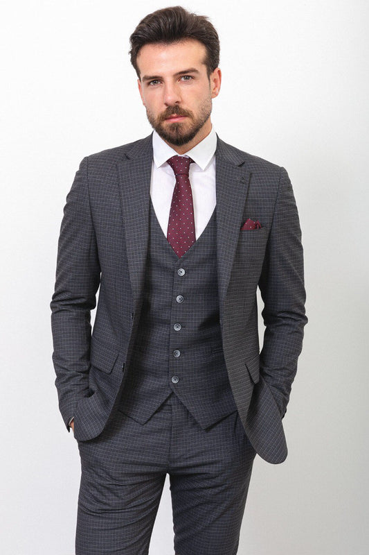 Man wearing a dark gray checkered suit with a burgundy tie and pocket square.