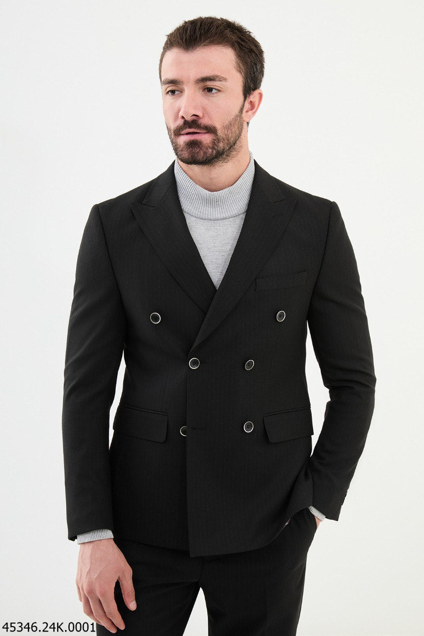 A man wearing a black double-breasted slim fit suit with a classic peak lapel.